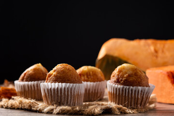 Pumpkin muffins on wooden table	