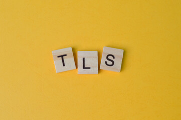 Wooden letters with text TLS stands for Transport Layer Security