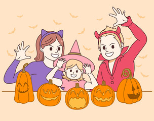 Happy family of mother father and daughter wearing Halloween costumes celebrating party with carved pumpkins and making scary gesture pose