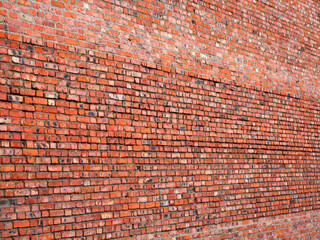 red brown brick wall with a shallow depth of field at an angle to the plane. Selective focus. grunge brick wall texture perspective view