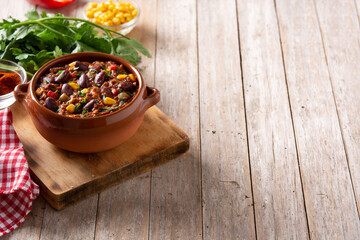 Traditional mexican tex mex chili con carne on wooden table.Copy space