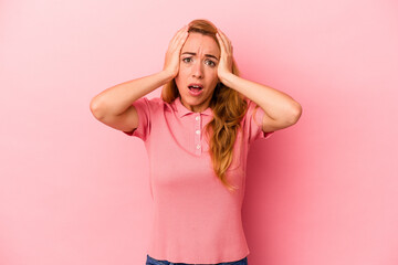 Caucasian blonde woman isolated on pink background being shocked, she has remembered important meeting.