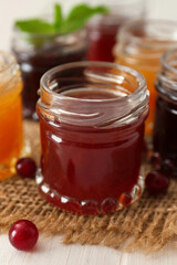 Jar of sweet jam on table, closeup
