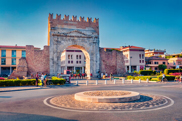 Colorful evening view of Arch of Augustus. Captivating summer cityscape of Rimini town, Italy, Europe. Traveling concept background..