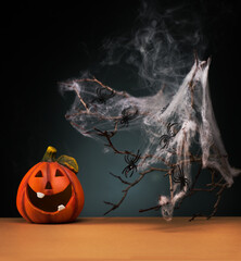 Halloween party concept with Funny Pumpkin, spider and spider web, on a dark background. Halloween decoration