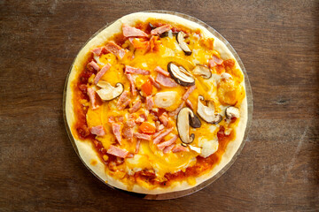 Top views Homemade seafood  pizza  in vintage plate  on old wooden background