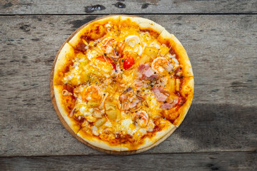 Top views Homemade seafood  pizza  in vintage plate  on old wooden background
