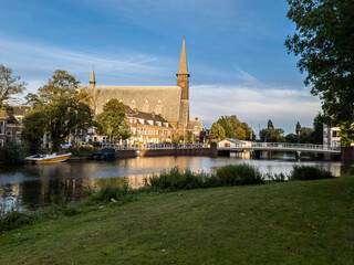 Fototapeta na wymiar church tower and water canal 