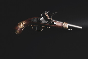Antique flintlock blunderbuss pistol isolated on black background