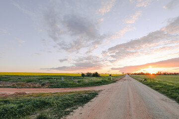 Fototapeta na wymiar Sun setting on country road in Central Victoria, Australia. Late afternoon in Australia.