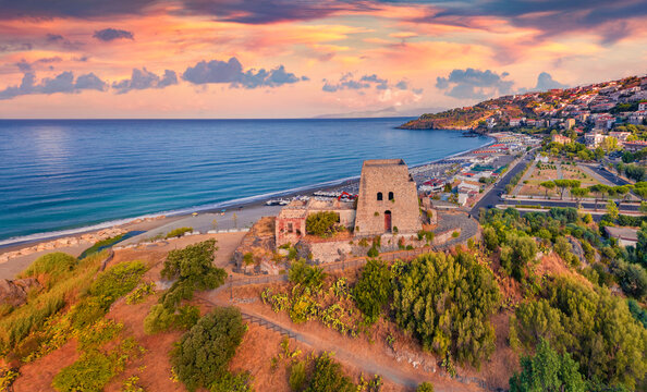 Impressive summer view from flying drone of historical place - Talao Tower. Colorful morning cityscape of Scalea town, Province of Cosenza, Italy. Traveling concept background..