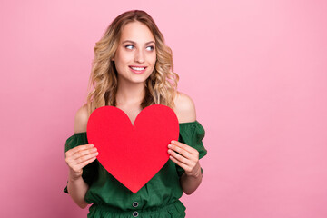 Photo of romantic lady hold red heart look empty space wear bear shoulders green blouse isolated pink color background