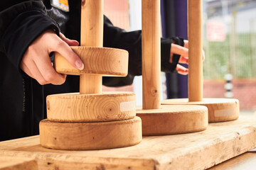 Closeup of white woman hands solving the tower of Hanoi puzzle ring stack game