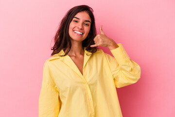 Young caucasian woman isolated on pink background showing a mobile phone call gesture with fingers.