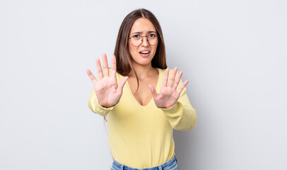 hispanic pretty woman feeling terrified, backing off and screaming in horror and panic, reacting to...