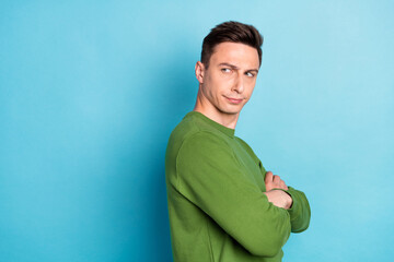 Photo of disappointed guy folded hands look empty space offended face wear green sweater isolated...