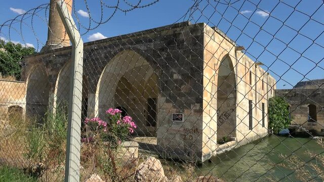 Halfeti, Sanliurfa, Turkey - 14th of June 2021: 4K Viewing the Halfeti sunken mosque behind barbed wire
