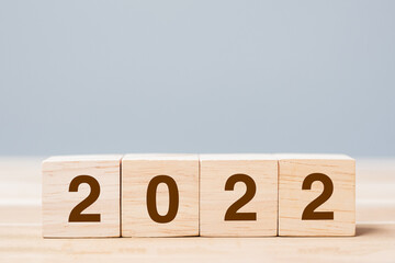 2022 wooden cube blocks on table background. Resolution, plan, review, goal, start and New Year...