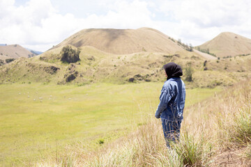 Young asian backpacker girl is happy and enjoy traveling in Wurung Crater (Kawah Wurung).