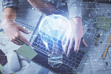 Double exposure of man and woman working together and bulb drawing. Computer background. Top View. Idea concept.