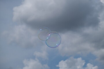 Soap bubbles with clouds in background