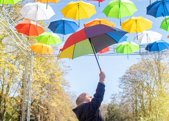 Colorful umbrellas. Bottom view. Conceptual art object. No labels or identification marks. Place for your text. Colorful background. Concept of a good mood and protection from problems. Sky is visible