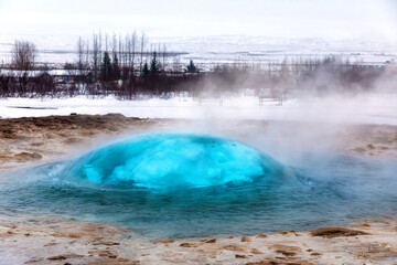 The famous Strokkur geyser erupting, Iceland. A blue bubble forms just as the geyser is about to erupt. 