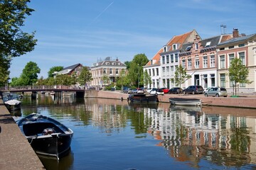 View of Haarlem, Holland, in a sunny day, with boats and reflections on the canal