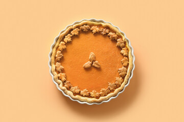 Traditional American Pumpkin Pie on beige background with copy space. View from above. Homemade pastry for Thanksgiving Day.