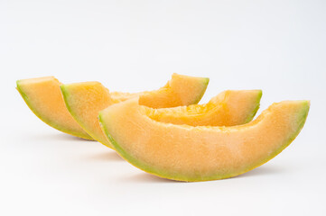 Fototapeta na wymiar melons ripe on a white background and in the beds