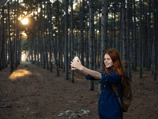 red-haired woman in forest nature travel walk freedom