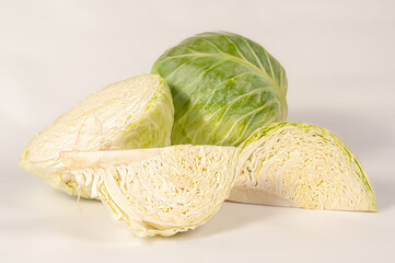 white cabbage ripe on a white background and in the beds