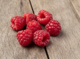 A group of raspberries over wooden table