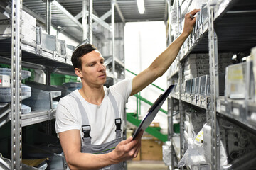 employees of a car repair shop in a warehouse for spare parts