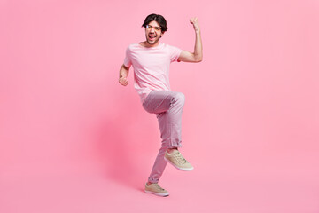 Fototapeta na wymiar Full length body size photo man happy gesturing like winner isolated pastel pink color background