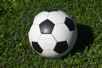 Fototapeta na wymiar Practice soccer ball sits on sideline while game is underway.