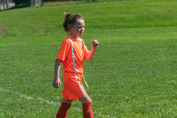 Young girl on Soccer Field running.  Granddaughter in youth sports in Kirkwood in Upstate NY in...