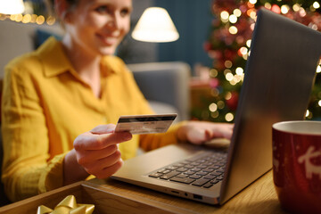 Happy woman doing online shopping at Christmas