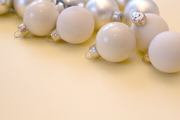 Christmas Decoration on light yellow pastel Background. New year balls. Close up local focus. copyspace. christmas card