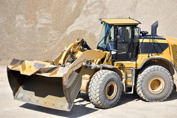 heavy construction machine in open-cast mining - wheel loader transports gravel in a gravel plant