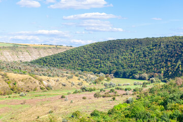 Fototapeta na wymiar Green landscape with hills and forest . Spectacular nature in the summer
