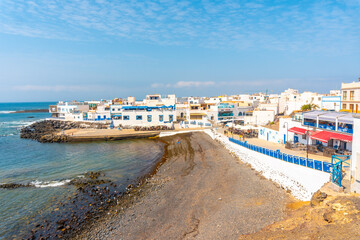 Black beach of the tourist town of El Cotillo in the north of the island of Fuerteventura, Canary Islands. Spain