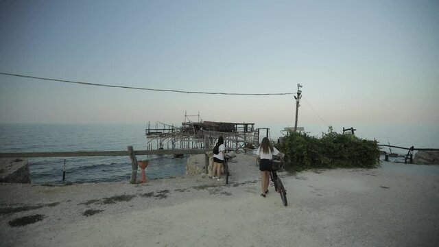 View of the sed at the sunset, Adriatic sea, rocs and sand of the italian coast. View of an old trebuchet