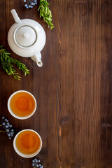 Asian food and drink set white teapot and black tea in two cups