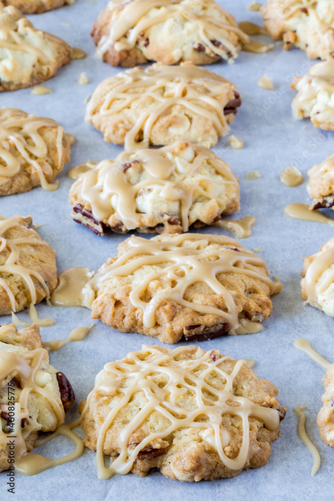Wall mural vertical rows of maple pecan cookies on a parchment lined cookie sheet.