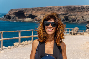 A young mother with her son walking on the path in the Cuevas de Ajuy, Pajara, west coast of the island of Fuerteventura, Canary Islands. Spain