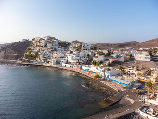 Fototapeta premium Aerial view of the beach and the coastal town of Las Playitas, east coast of the island of Fuerteventura, Canary Islands. Spain