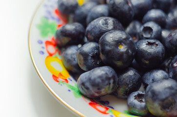 Closeup on fresh and ripe blueberries on a white background