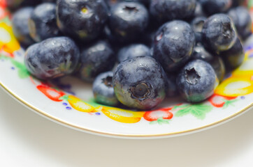 Closeup on fresh and ripe blueberries on a white background