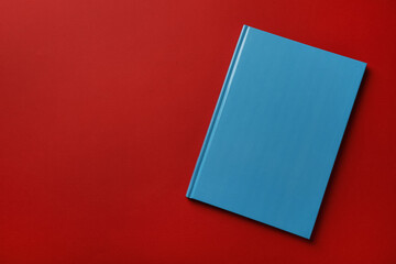 New stylish planner with hard cover on red background, top view. Space for text - obrazy, fototapety, plakaty
